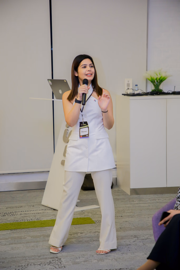Gauravi speaking on the mic at a design event