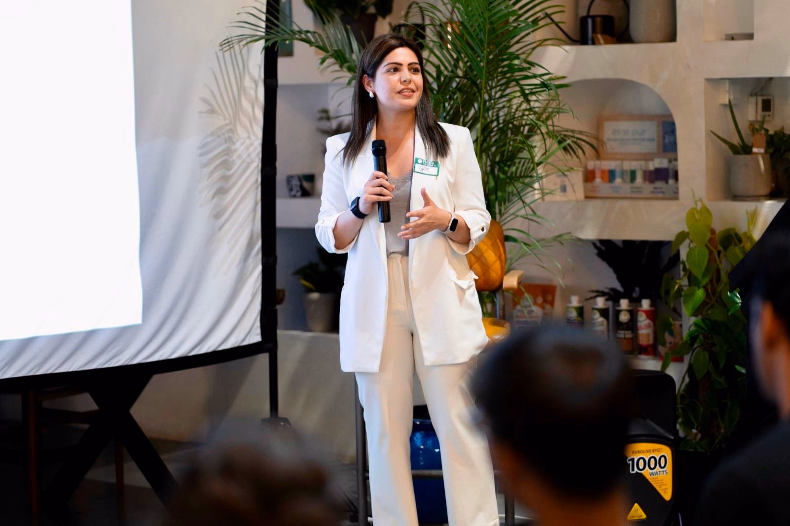 Gauravi presenting on stage to an audience